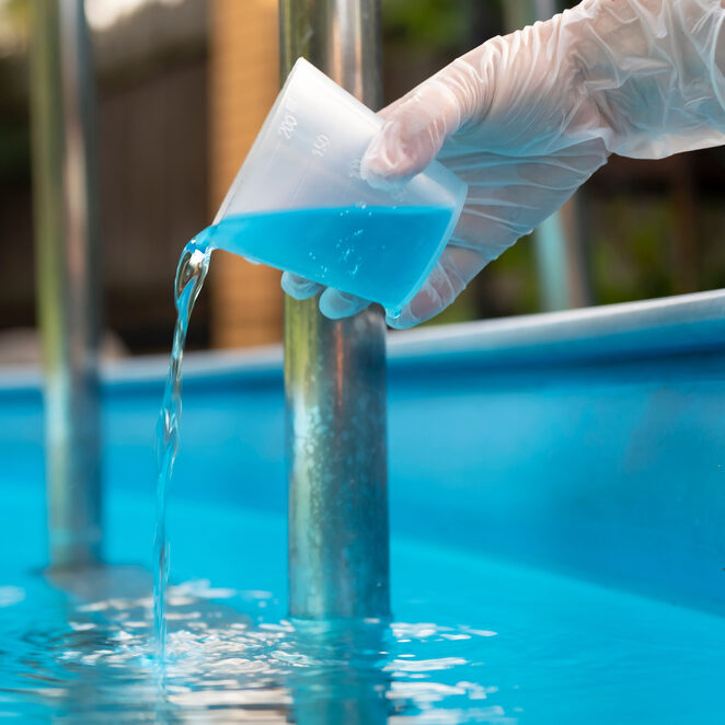 Chemical treatment being added to a pool